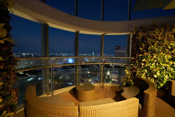 stock image HO CHI MINH CITY, VIETNAM - MARCH 26, 2023: view of outdoor terrace at OnTop Bar, a rooftop bar located on the 20th floor at Novotel Saigon Centre.