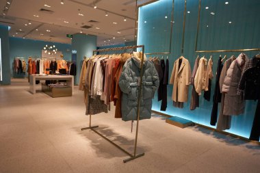 SHENZHEN, ÇİN - 29 Kasım 2019: Shenzhen Vanke Plaza alışveriş merkezindeki Co.One mağazasının içinde çeşitli giysiler var..