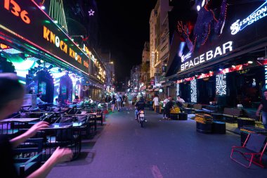 HO CHI MINH CITY, VIETNAM - MARCH 29, 2023: view of Bui Vien Walking Street in Ho Chi Minh City at nighttime. clipart