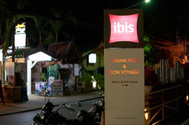 PHUKET, THAILAND - APRIL 25, 2023: ibis hotel Phuket Patong sign as seen in the night. clipart