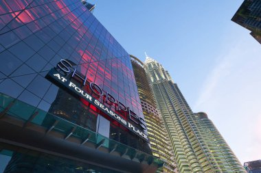 KUALA LUMPUR, MALAYSIA - 29 Mayıs 2023: Akşam karanlığında Petronas Kuleleri ile Four Seasons Place 'de alışveriş.