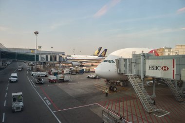 SINGAPORE - NOVEMBER 10, 2015: a Singapore Airlines Airbus A380 with aircrafts on tarmac in the background, as seen in Changi Airport. clipart