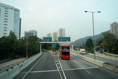 HONG KONG, ÇİN - 04 Aralık 2023: Hong Kong 'daki çift katlı otobüsün ikinci masasından görüldüğü gibi şehir manzarası.