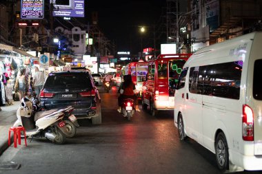 PHUKET, THAILAND - 25 Nisan 2023: Patong, Phuket 'te gece vakti tuk-tuk yoğunluğunun sokak seviyesi görünümü.