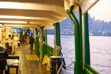 HONG KONG, CHINA - DECEMBER 05, 2023: on board of a Star Ferry during crossing Victoria Harbour. The Star Ferry is a passenger ferry service operator and tourist attraction in Hong Kong. clipart