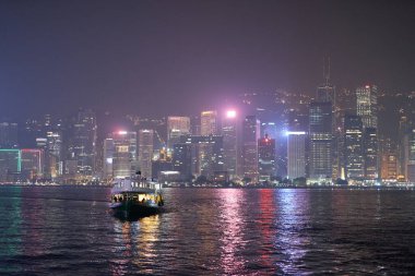 HONG KONG, CHINA - DECEMBER 05, 2023: a Star Ferry crossing Victoria Harbour. The Star Ferry is a passenger ferry service operator and tourist attraction in Hong Kong. clipart