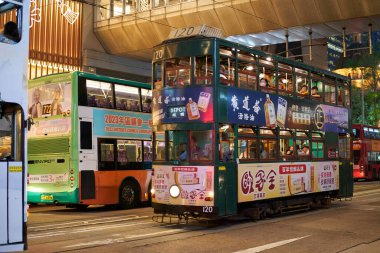 HONG KONG, CHINA - DECEMBER 05, 2023: a double-decker tram as seen in Central District at nighttime. clipart