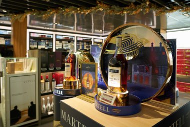 HONG KONG, CHINA - DECEMBER 08, 2023: bottle of Cognac Martell displayed at Duty Zero by cdf in Hong Kong International Airport. clipart