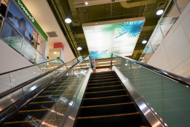 PHUKET, THAILAND - APRIL 30, 2023: an escalator inside Jungceylon shopping center. clipart