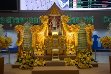 BANGKOK, THAILAND - OCTOBER 14, 2023: King Rama IX portrait on display at Don Mueang International Airport. clipart