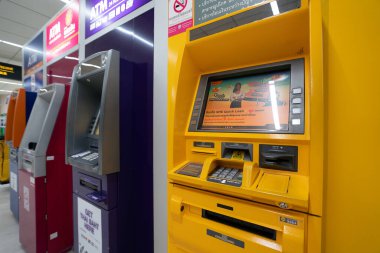 BANGKOK, THAILAND - OCTOBER 14, 2023: assortment of automated teller machines as seen in Don Mueang International Airport. clipart