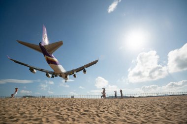 PHUKET, THAILAND - JANUARY 23, 2020: a Thai Airways Boeing 747-400 aircraft landing at Phuket International Airport. clipart