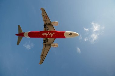 PHUKET, THAILAND - JANUARY 22, 2020: planform view of an AirAsia Airbus A320 aircraft landing at Phuket International Airport. clipart