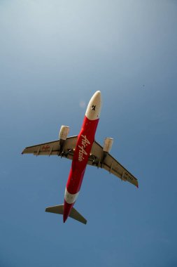 PHUKET, THAILAND - JANUARY 22, 2020: planform view of an AirAsia Airbus A320 aircraft landing at Phuket International Airport. clipart