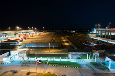 KUALA LUMPUR, MALAYSIA - MARCH 06, 2023: airplanes on tarmac at Kuala Lumpur International Airport. clipart