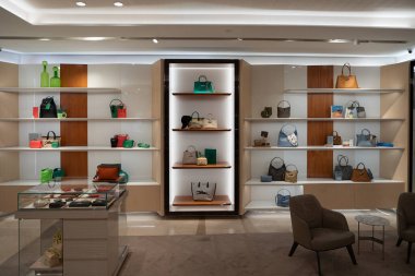 KUALA LUMPUR, MALAYSIA - MARCH 15, 2023: bags on display at Longchamp store inside Suria KLCC shopping mall in Kuala Lumpur. Longchamp is a French leather goods company. clipart