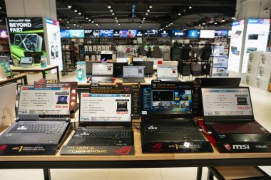 KUALA LUMPUR, MALAYSIA - MARCH 12, 2023: various laptops on display at Brightstar store, Plaza Low Yat mall in Kuala Lumpur clipart