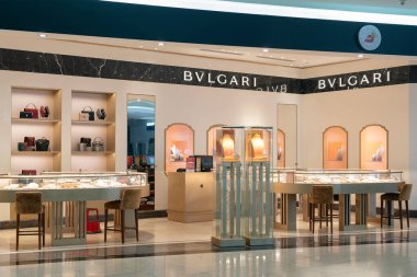 DUBAI, UAE - FEBRUARY 21, 2019: goods on display at BVLGARI store in Dubai International Airport. Bulgari is an Italian luxury fashion house. clipart