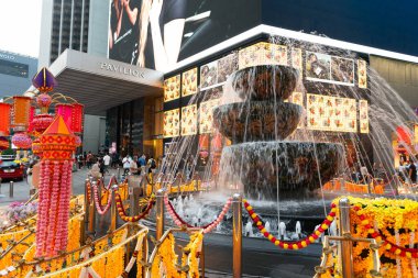 KUALA LUMPUR, MALAYSIA - NOVEMBER 08, 2023: street-level view of Pavilion Crystal Fountain at Pavilion Kuala Lumpur, with its iconic Liuli crystal bowls symbolizing unity, harmony, and prosperity. clipart