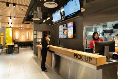 KUALA LUMPUR, MALAYSIA - 01 Aralık 2023: McDonald 's restoranındaki servis sayacı. McDonald 's, hamburgerleri, kızartmaları ve diğer fast-food yemekleri ile bilinen küresel bir fast-food zinciri..