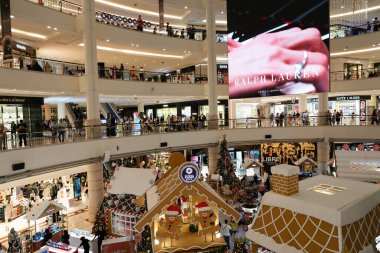 KUALA LUMPUR, MALAYSIA - DECEMBER 02, 2023: Christmas decorations in the atrium at Suria KLCC. Suria KLCC is a large, upscale shopping mall at the base of the Petronas Twin Towers. clipart