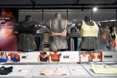 KUALA LUMPUR, MALAYSIA - DECEMBER 02, 2023: interior shot of Nike store in Suria KLCC. Nike is a global corporation that designs and sells athletic footwear, apparel, and equipment. clipart