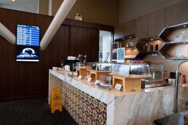 KUALA LUMPUR, MALAYSIA - DECEMBER 03, 2023: buffet area at Malaysia Airlines Regional Golden Lounge KLIA. The lounge is located on the Mezzanine Floor of the International Main Terminal Building. clipart