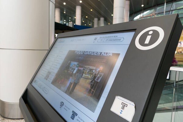 KUALA LUMPUR, MALAYSIA - DECEMBER 03, 2023: close up shot of interactive information kiosk in KLIA. It is a digital display providing self-service information and assistance to travelers.