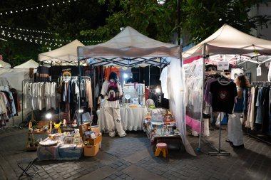 CHIANG MAI, THAILAND - OCTOBER 24, 2023:  market stalls as seen in Chiang Mai at nighttime. clipart