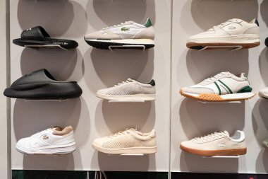 SINGAPORE - 25 Ağustos 2024: Changi Uluslararası Havaalanı 'ndaki Lacoste mağazasında ayakkabılar sergileniyor