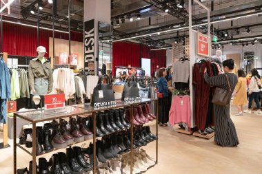 Shenzhen, China - February 06, 2019: interior shot of a Bershka store in UpperHills shopping mall. Bershka is a Spanish retailer offering clothing and accessories. clipart