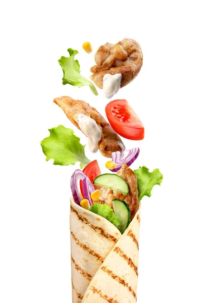 pita bread with flying vegetables and chicken on a white background