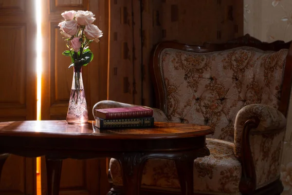 背景に椅子を背景に花瓶に花を咲かせ — ストック写真