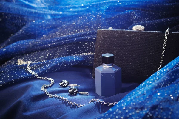 Garrafa Perfume Embreagem Preta Jóias Fundo Vestido Noite Azul — Fotografia de Stock