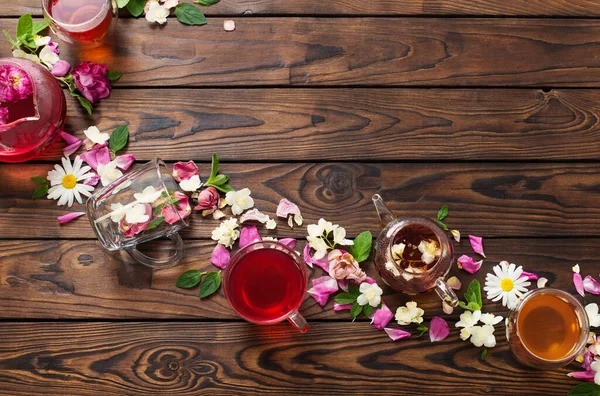 Különböző Teák Gyógynövényekkel Virágokkal Egy Sötét Asztalon Felülnézetből — Stock Fotó