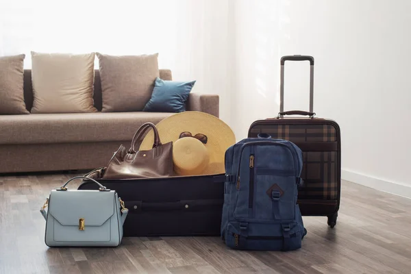suitcases packed for travel on  living room floor