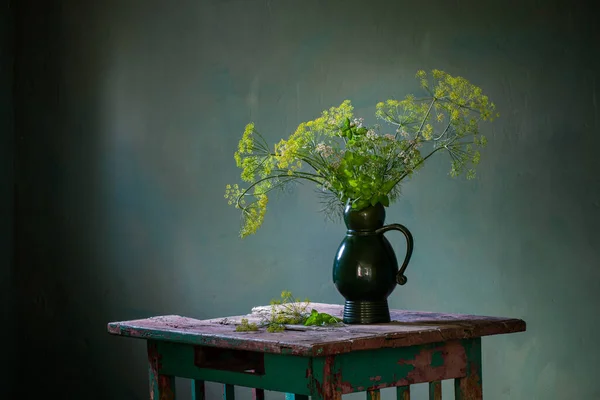 陈腐的花束 用瓷壶装饰在深色背景的旧木桌上 — 图库照片