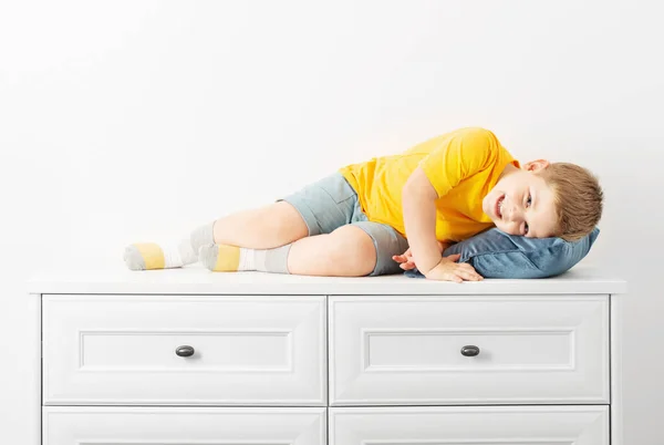 Funny Boy Lying Dresser White Background — Stock Photo, Image