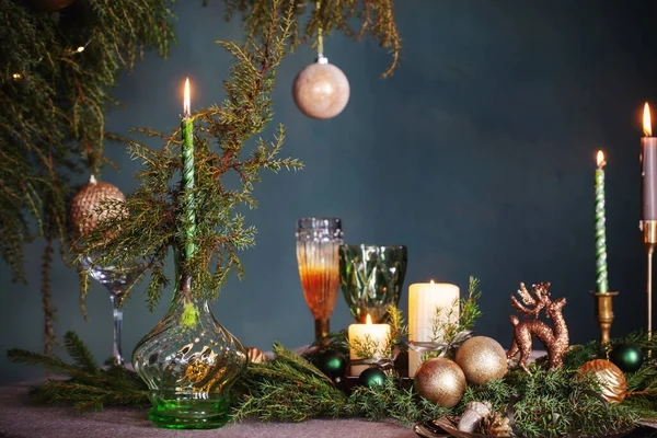 green and golden christmas decor on table on dark background