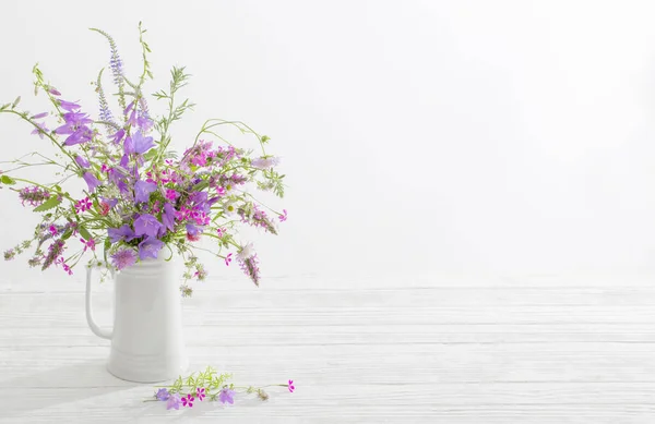 白色背景的白色水壶中的夏天野花 — 图库照片