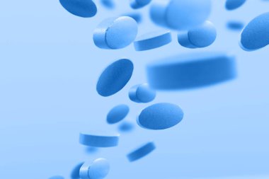 Mavi arka planda uçan mavi haplar