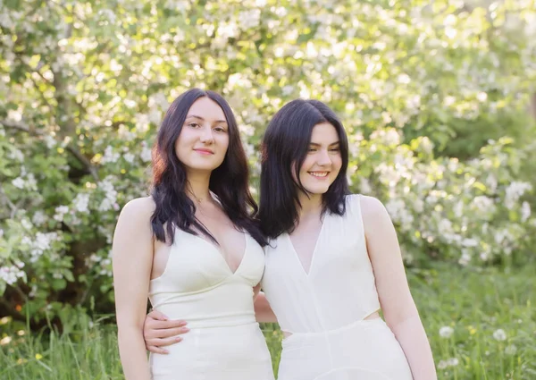 Twee Jonge Meisjes Witte Jurk Achtergrond Bloeiende Appelboom — Stockfoto