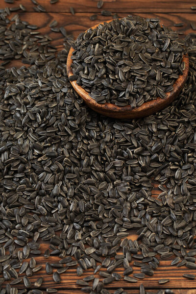 black sunflower seeds on  wooden table