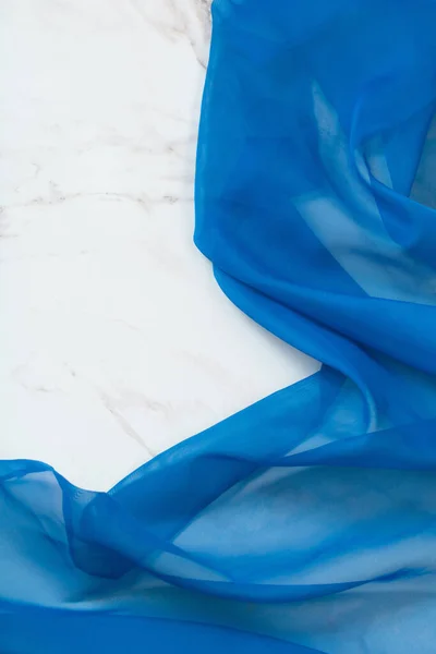 blue cloth on white marble background