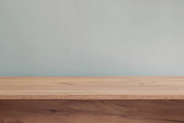 stock image background with modern wooden table and blue  wall