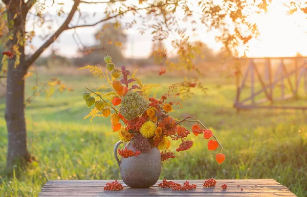 Bouquet Autumn Flowers Rustic Jug Wooden Table Outdoor Sunset — Stock Photo, Image