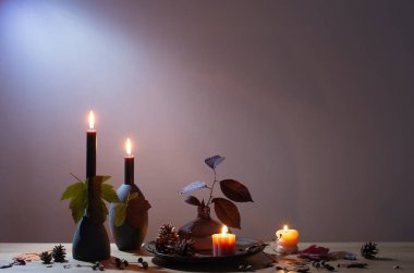 Arka plandaki ahşap rafta mumlar olan sonbahar karanlık dekoru