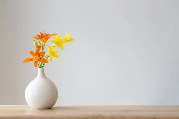 stock image summer flowers in white modern vase on wooden shelf