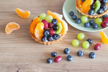 Mutfaktaki ahşap masada meyveli kekler.