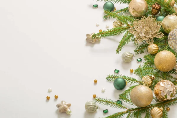 Beyaz arkaplanda altın ve yeşil noel süslemeleri